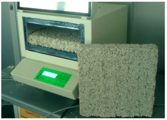 Heat flow meter—Fox 314 apparatus with the hemp–lime composite (Wall mix A) sample.
