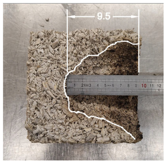 Depth of material burnout after hemp concrete flammability test. (Source: own photo).