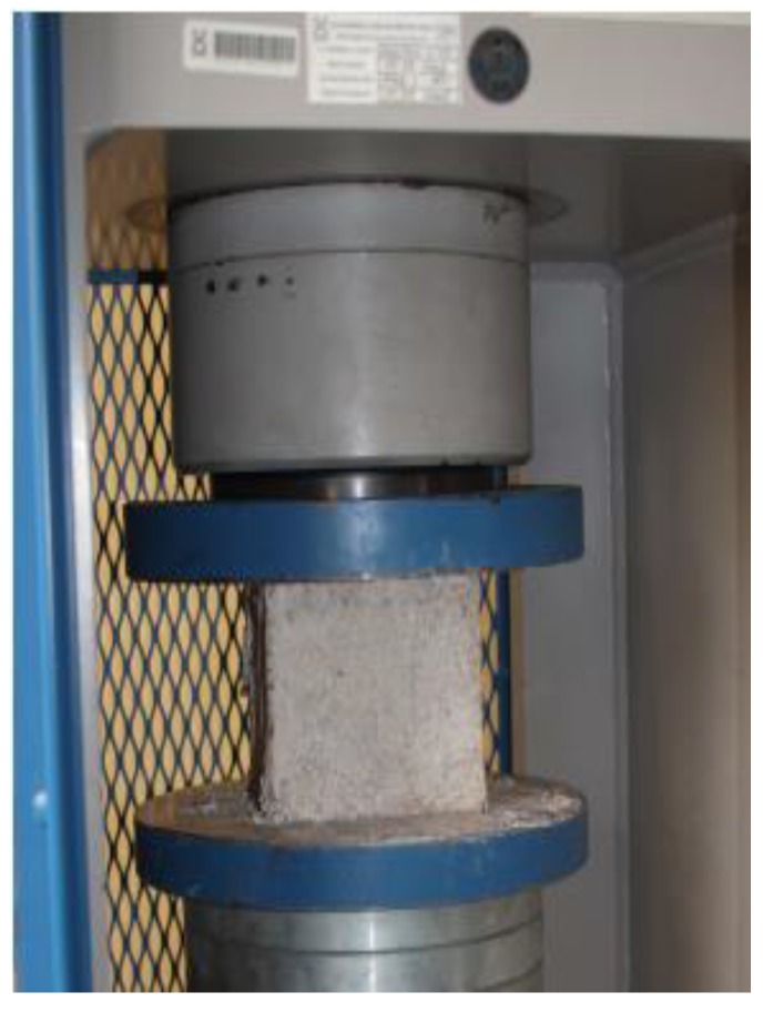 Test composite specimen in the device for determination of compressive strength.