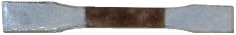 Tensile test specimen partial reinforced with jute fiber.