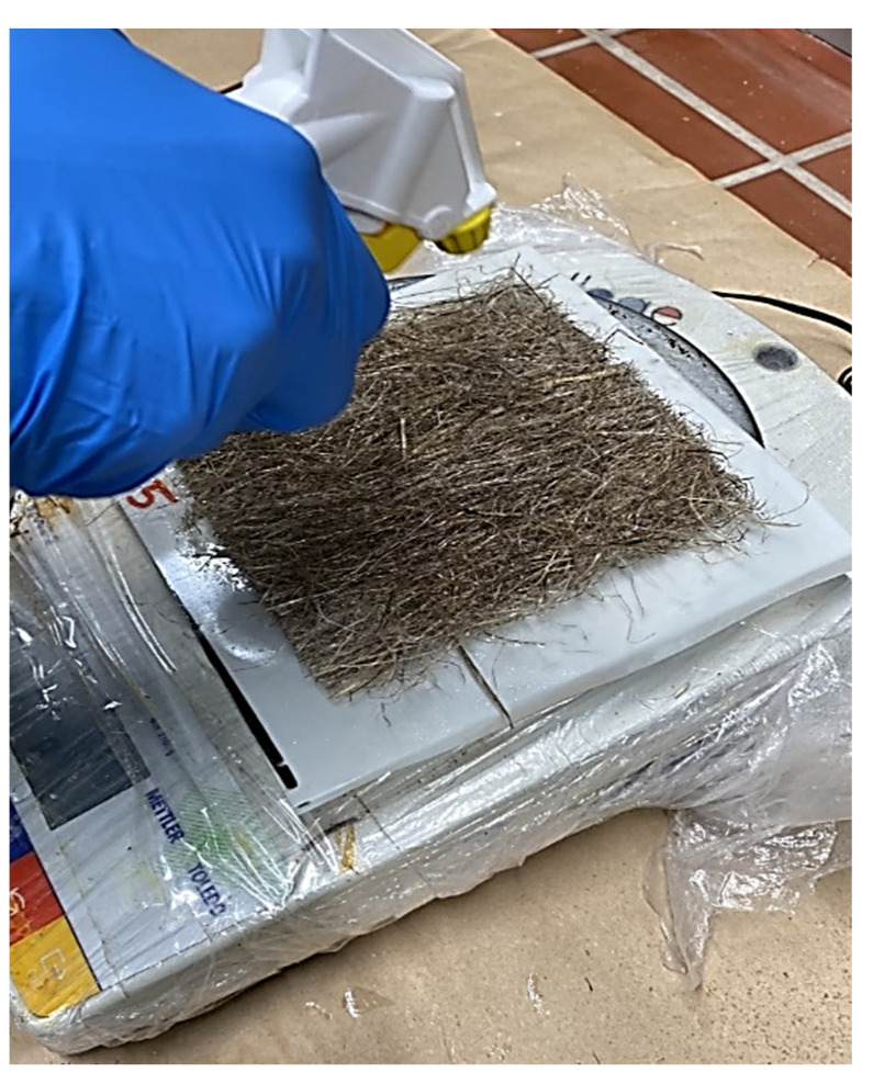 Coating of hemp fiber mats with Palonot fire retardant.