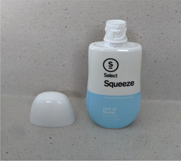This image displays a front view of the select squeeze bottle with the child-resistant safety cap removed, revealing the bottleneck of the device which contains the dosage reservoir